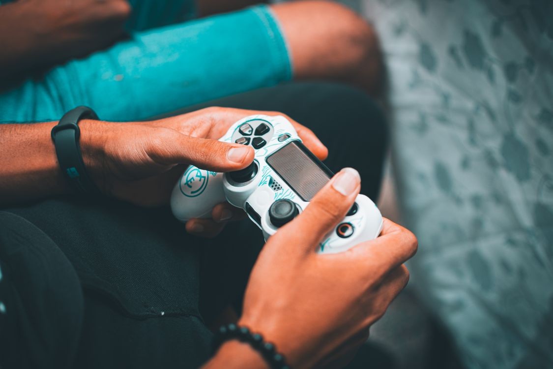 Hands holding a gaming controller, concept photo